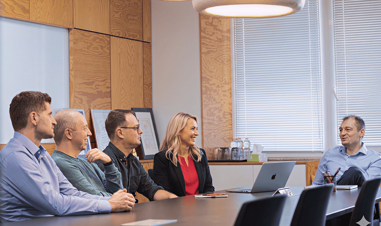 LogiNet team members in a meeting room discussing a project
